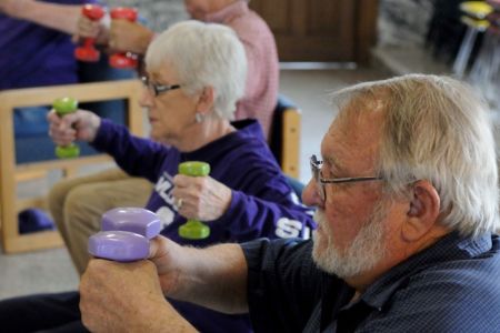 Senior Citizens participation in Stay Strong, Stay Healthy. A male and female lifting weights 